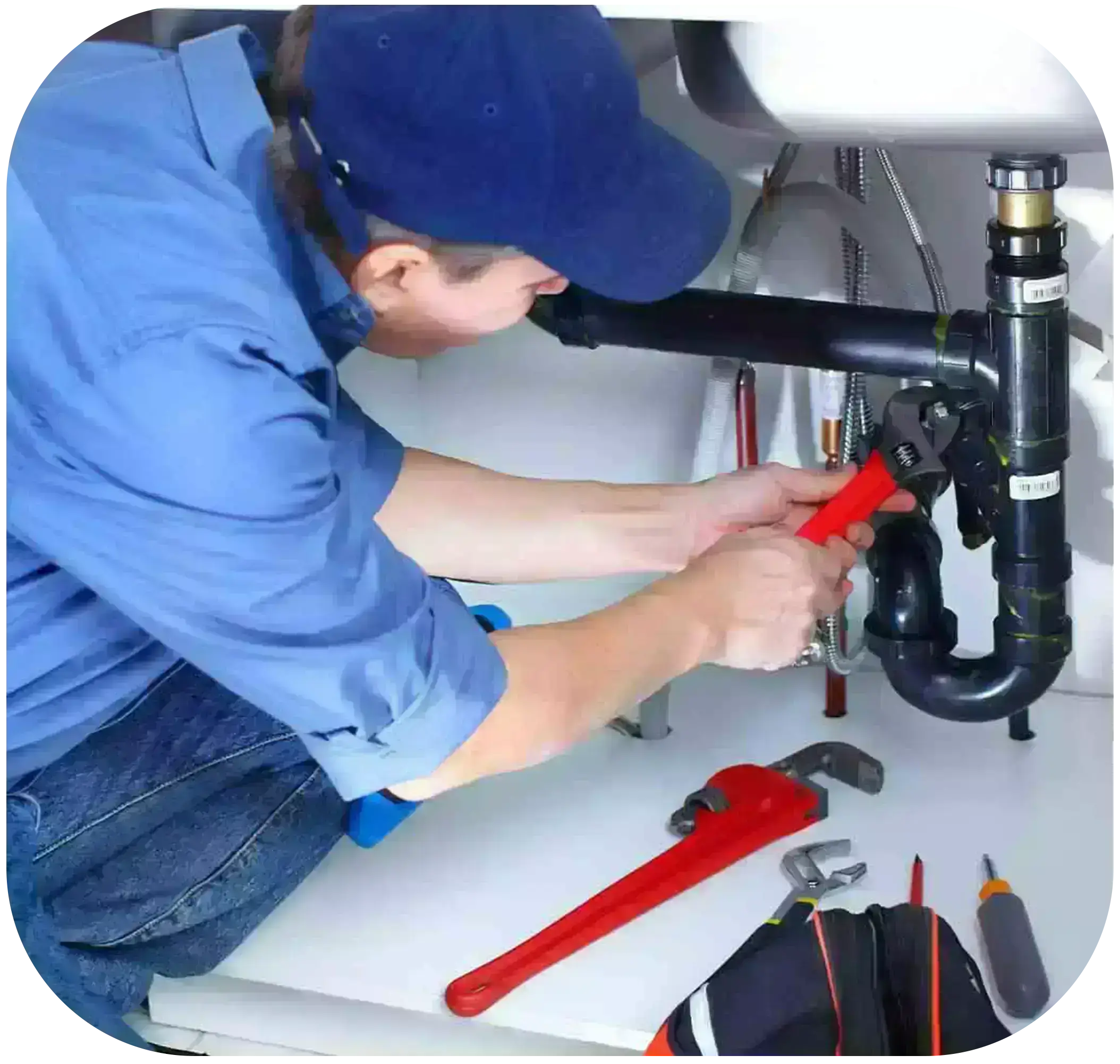 A technician uses pliers to repair a water pipe.